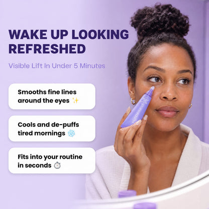 A woman in a white robe applies a purple eye cream from a tube to her upper eyelid